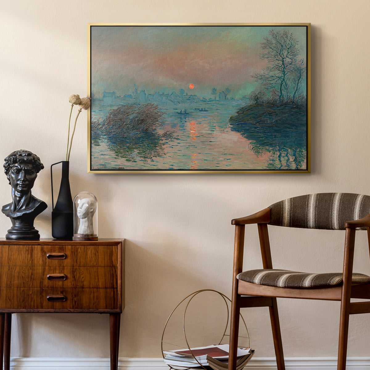 Sunset on the Seine at Lavacourt, Winter Effect, 1880 by Claude Monet as a gold floater framed canvas featuring an impressionist view of river at sunset with snowy banks, styled above a mid-century console in a contemporary living area.