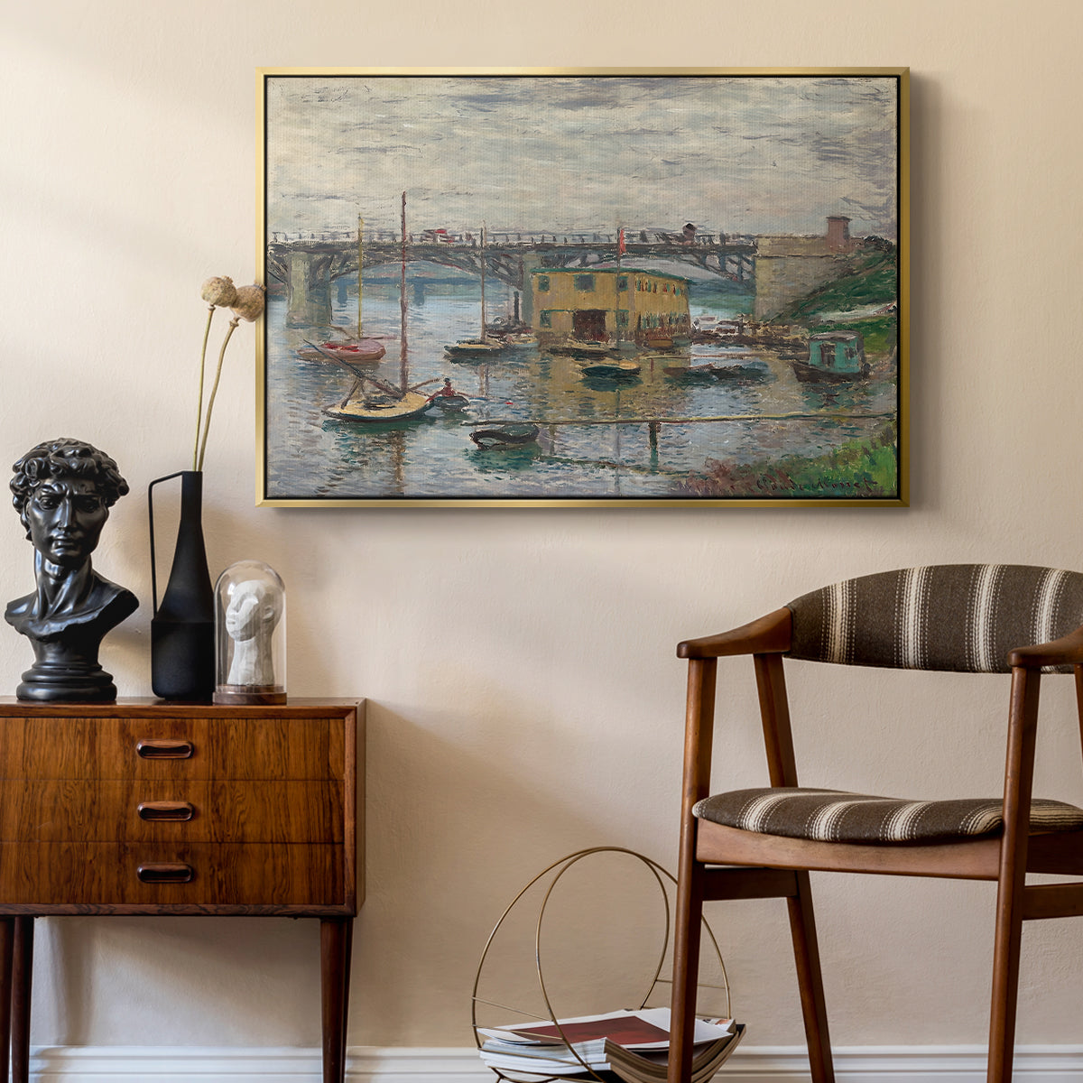Bridge at Argenteuil on a Gray Day, c. 1876 by Claude Monet as a gold floater framed canvas featuring a calm water scene with bridge fading into cloudy sky, styled above a mid-century console in a contemporary living area.