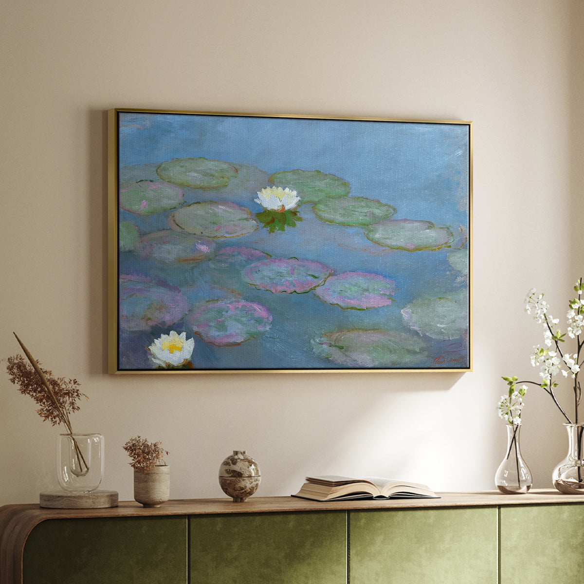 Gold floater framed canvas of Water Lilies (Nymphéas), 1897-1899 by Claude Monet, featuring an impressionist pond scene with lily pads and soft reflections above a sideboard in a softly lit hallway.