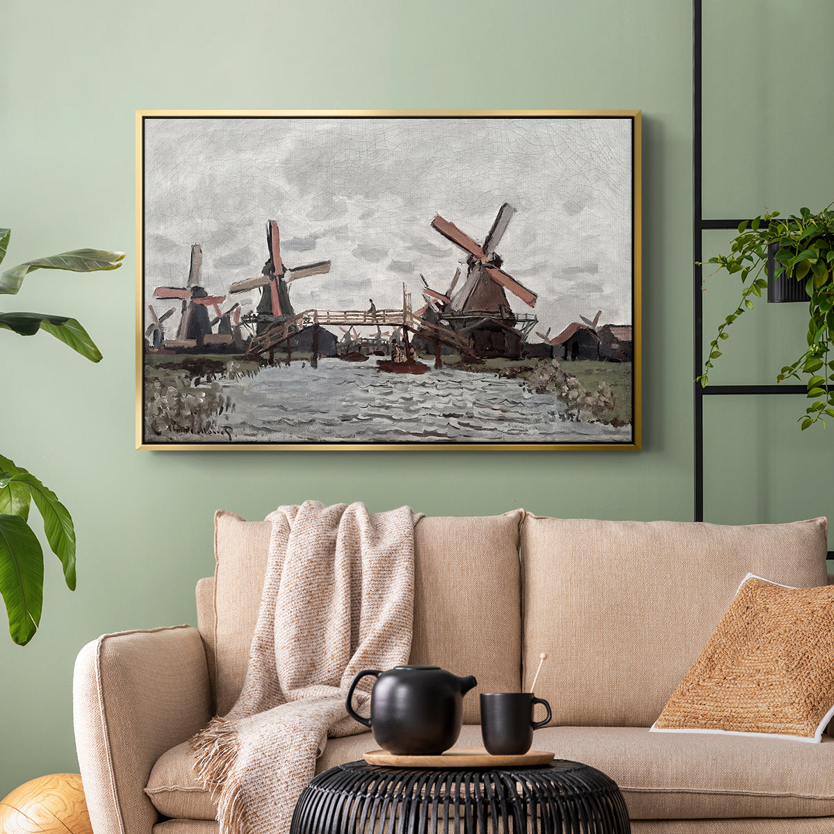 Gold floater framed canvas featuring a landscape featuring windmills and low horizon sky, displayed above a sofa in a modern living room.