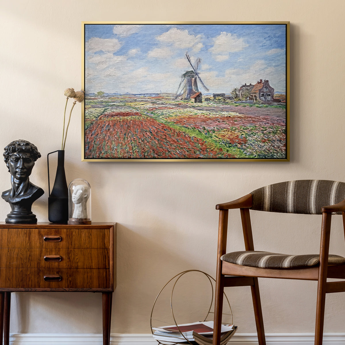 Tulip Fields with the Rijnsburg Windmill, 1886 by Claude Monet as a gold floater framed canvas featuring an impressionist field of blooming tulips under bright sky, styled above a mid-century console in a contemporary living area.