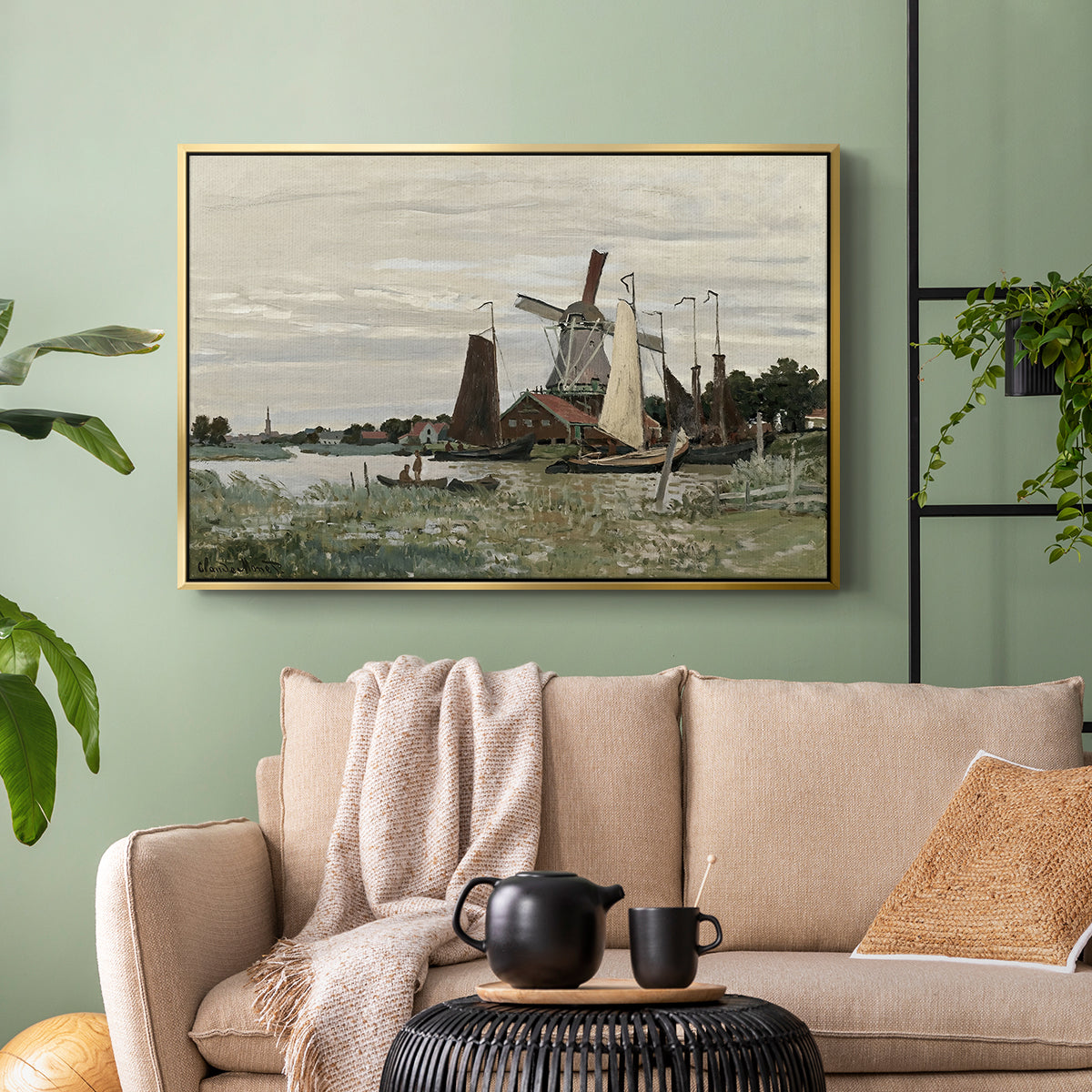 Gold floater framed canvas featuring a countryside structure standing against open sky, displayed above a sofa in a modern living room.