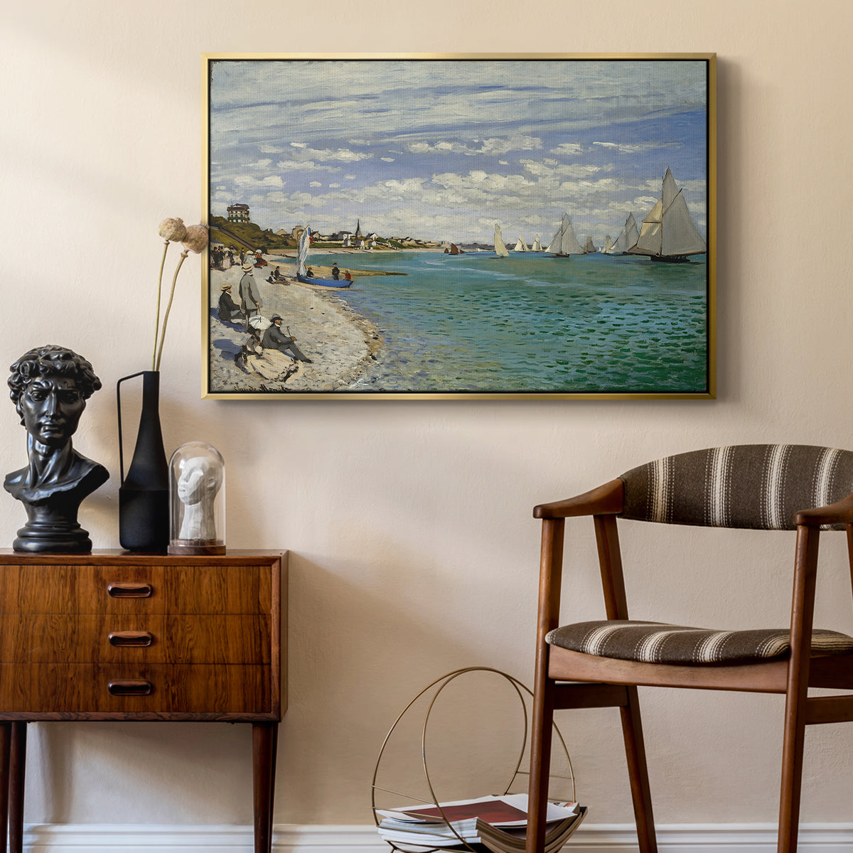 Regatta at Sainte-Adresse, 1867 by Claude Monet as a gold floater framed canvas featuring an impressionist coastal view with colorful sails and shoreline activity, styled above a mid-century console in a contemporary living area.