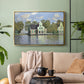 Gold floater framed canvas featuring a waterfront architecture with still reflections, displayed above a sofa in a modern living room.