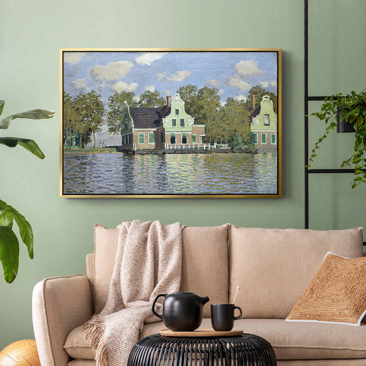 Gold floater framed canvas featuring a waterfront architecture with still reflections, displayed above a sofa in a modern living room.