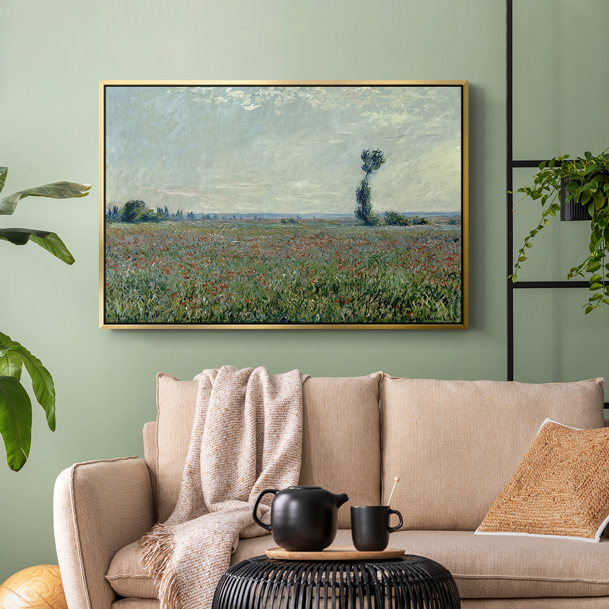Gold floater framed canvas featuring a natural field scene with vibrant red flowers, displayed above a sofa in a modern living room.