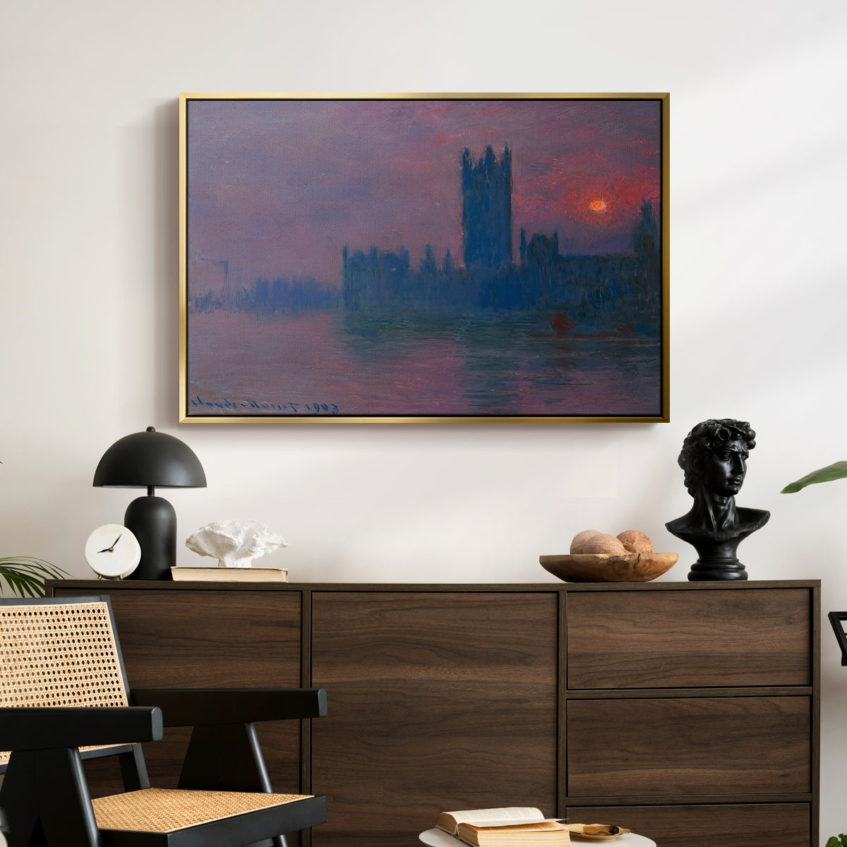 The Houses of Parliament, Sunset, 1903 by Claude Monet displayed in a gold floater framed canvas above a dark wood credenza in an entryway.