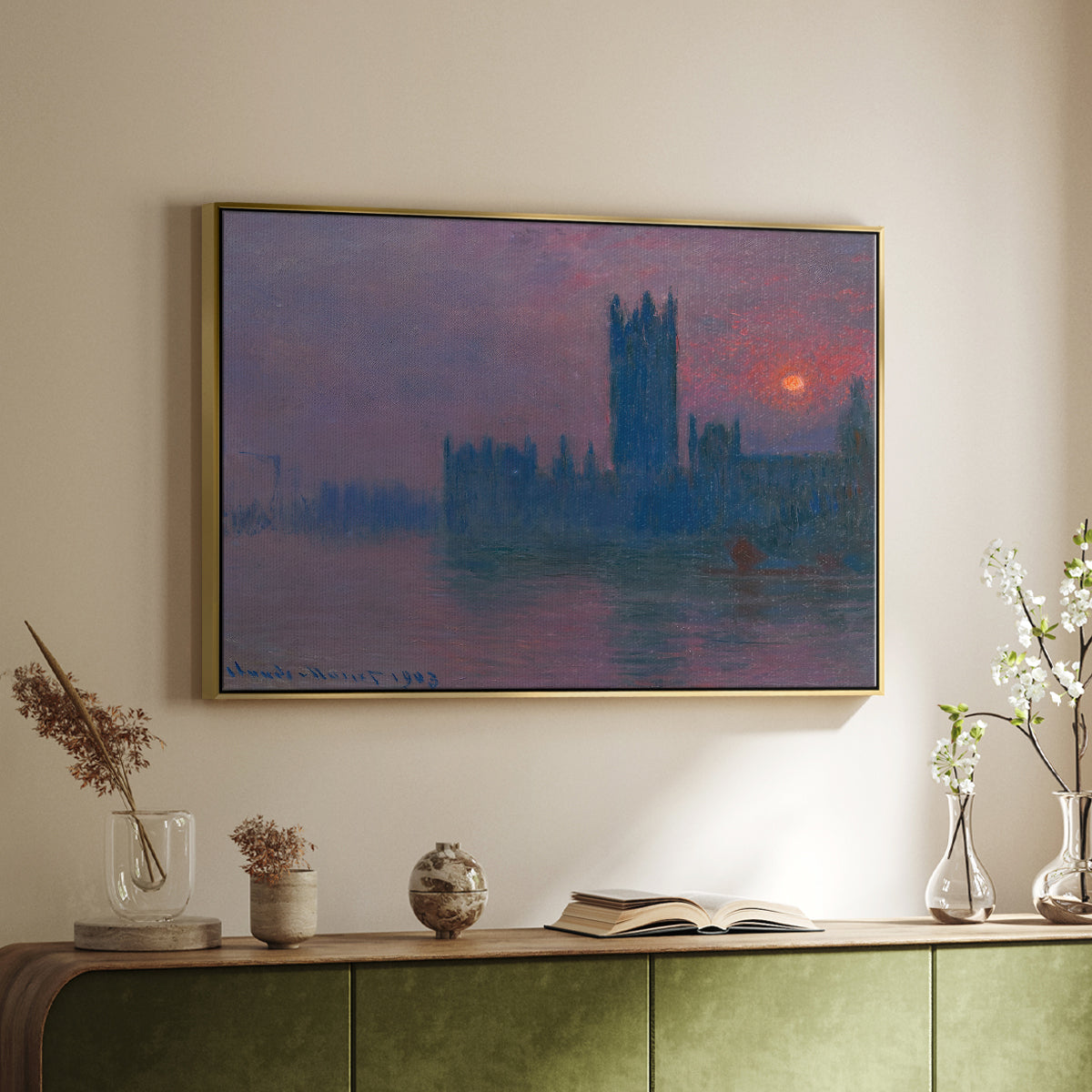 Gold floater framed canvas of The Houses of Parliament, Sunset, 1903 by Claude Monet, featuring an impressionist cityscape with warm sunset light over water above a sideboard in a softly lit hallway.