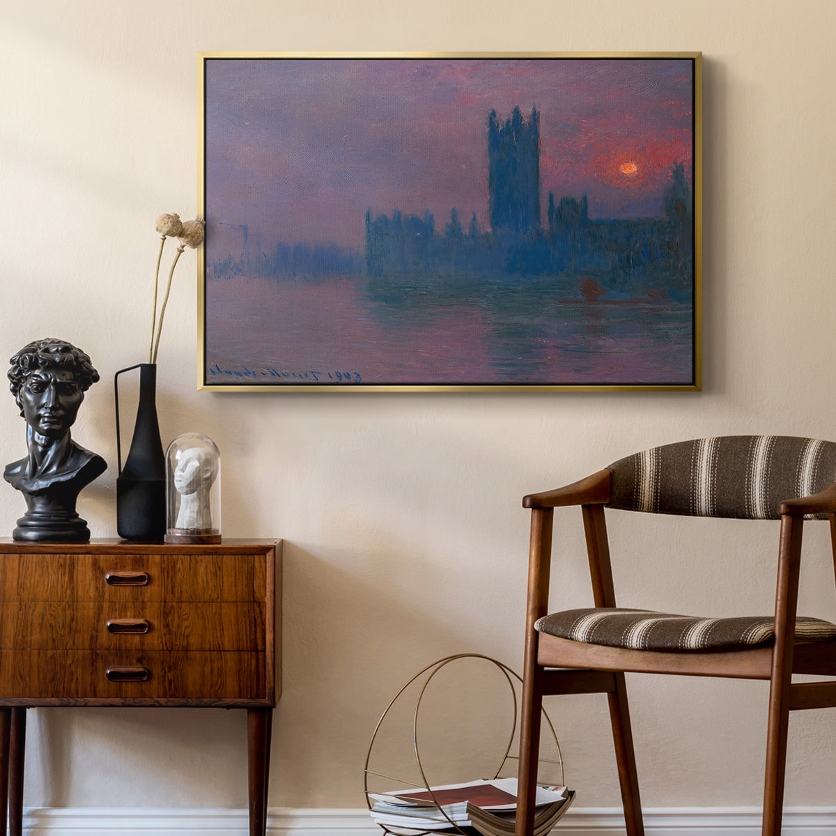 The Houses of Parliament, Sunset, 1903 by Claude Monet as a gold floater framed canvas featuring an atmospheric London scene with buildings fading into haze, styled above a mid-century console in a contemporary living area.