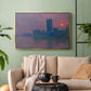 Gold floater framed canvas featuring a dramatic skyline with reflections under colorful sky, displayed above a sofa in a modern living room.