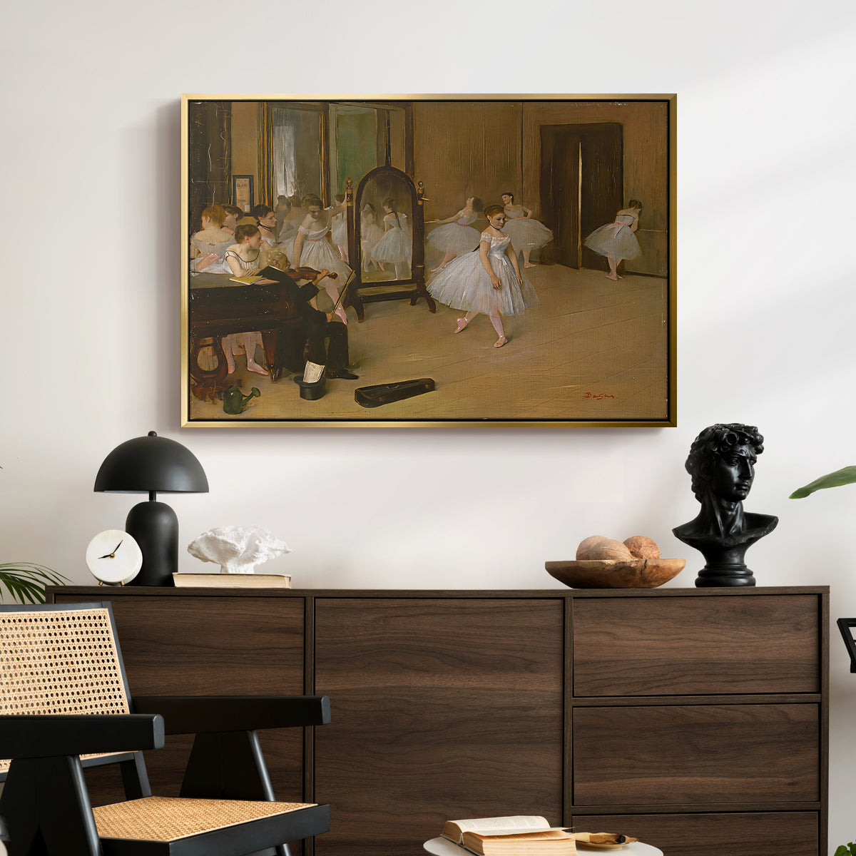 The Dancing Class, c. 1870 by Edgar Degas displayed in a gold floater framed canvas above a dark wood credenza in an entryway.