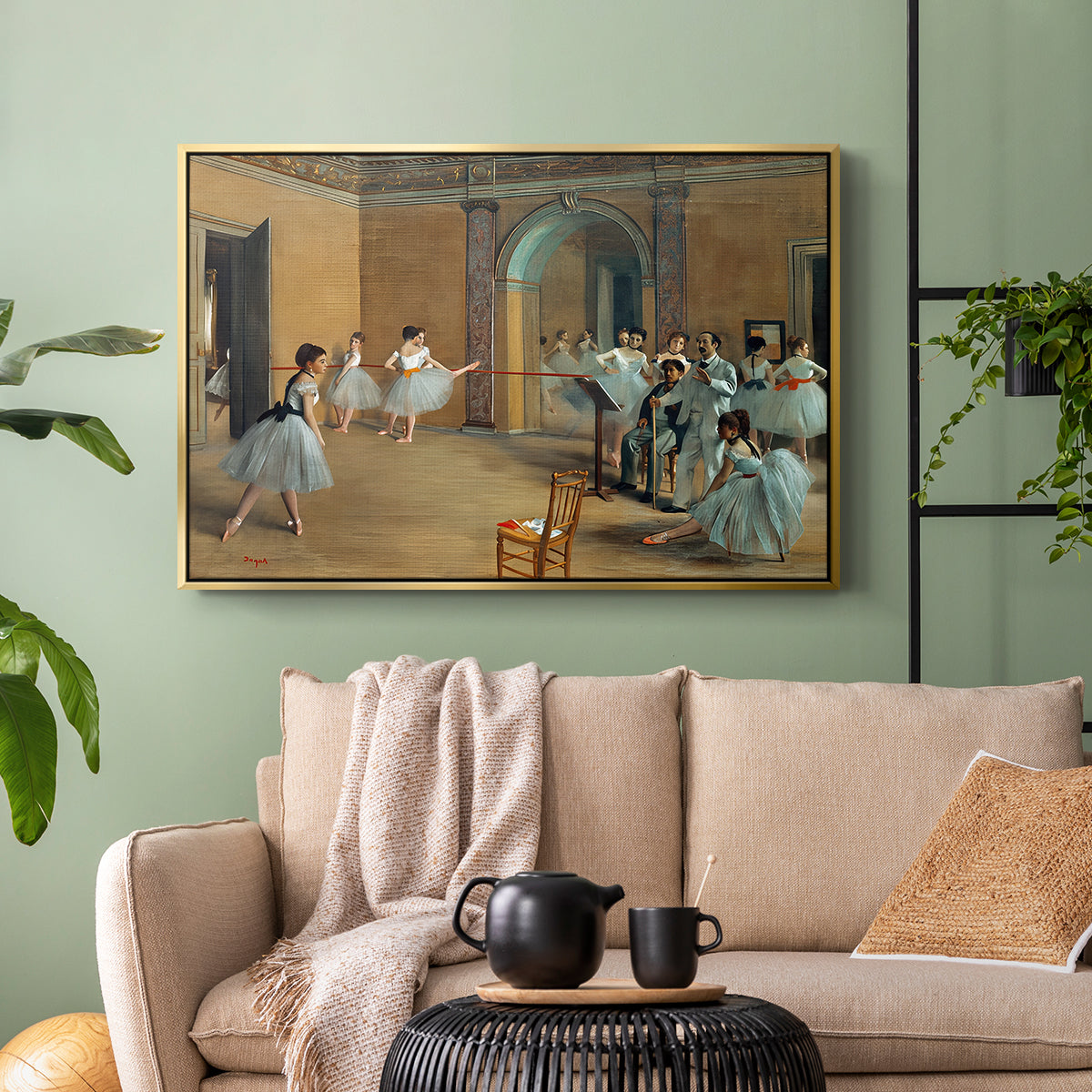 Gold floater framed canvas featuring an elegant rehearsal space with dancers in soft lighting, displayed above a sofa in a modern living room.