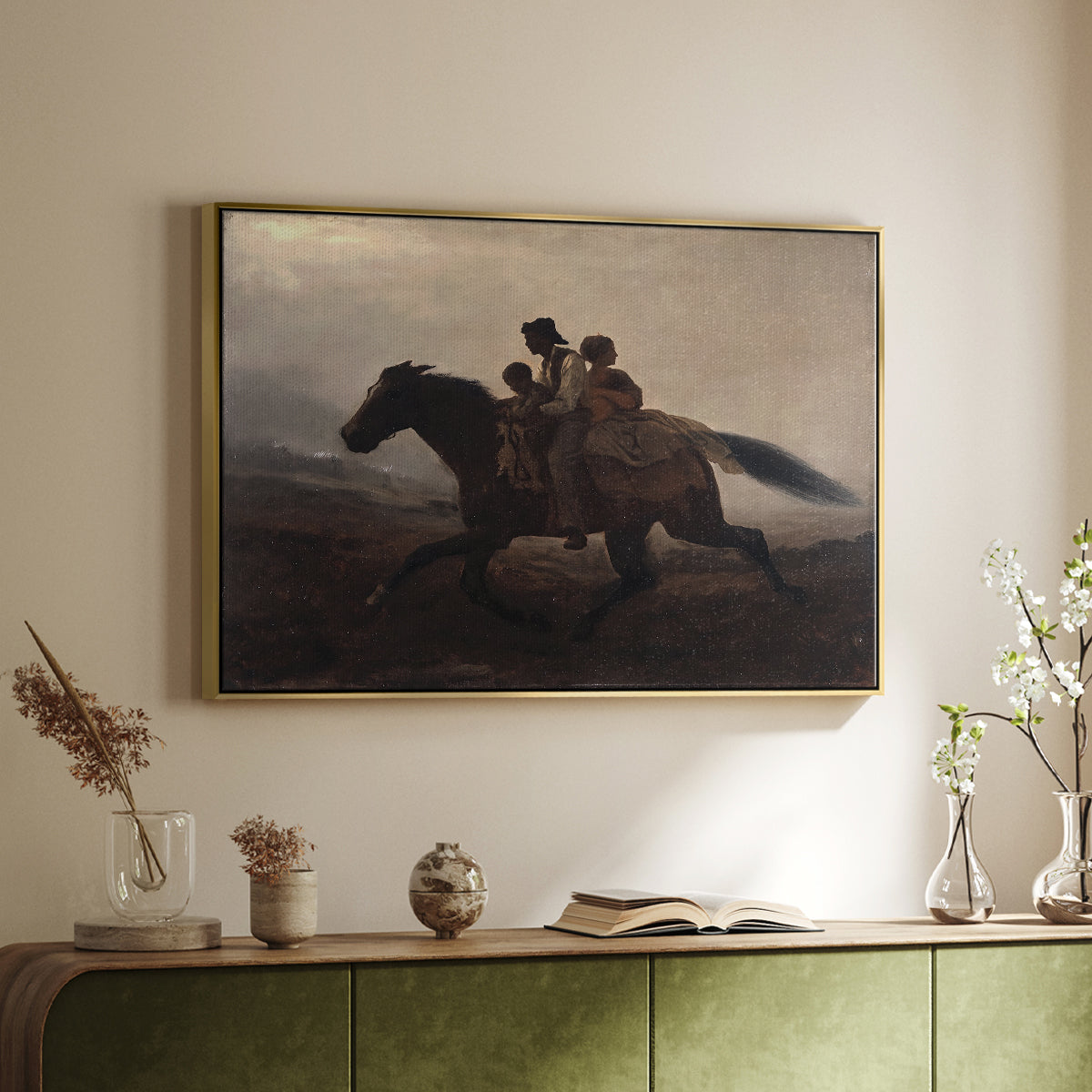 Gold floater framed canvas of A Ride for Liberty – The Fugitive Slaves, c. 1862 by Eastman Johnson, featuring a dramatic scene of enslaved people fleeing on horseback in darkness above a sideboard in a softly lit hallway.