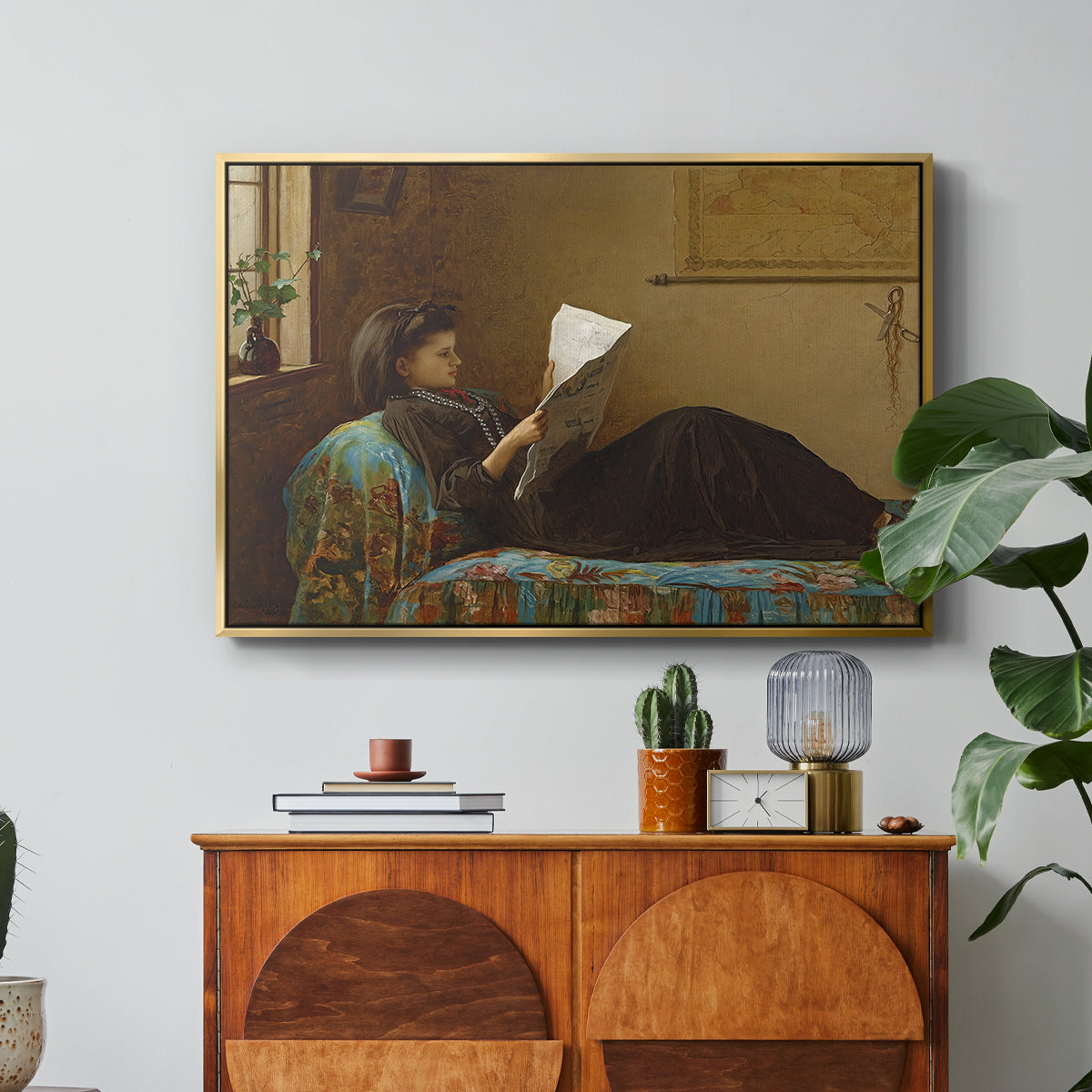 Interesting News, 1872 by Eastman Johnson in a gold floater framed canvas featuring a group of people gathered indoors reading newspaper together, displayed above a wood console cabinet.
