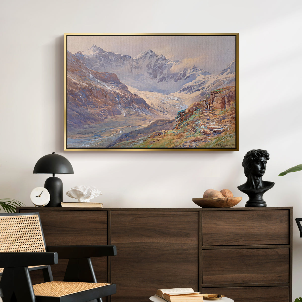 Odenwinklkees with the Johannisberg, 1902 by Edward Theodore Compton displayed in a gold floater framed canvas above a dark wood credenza in an entryway.