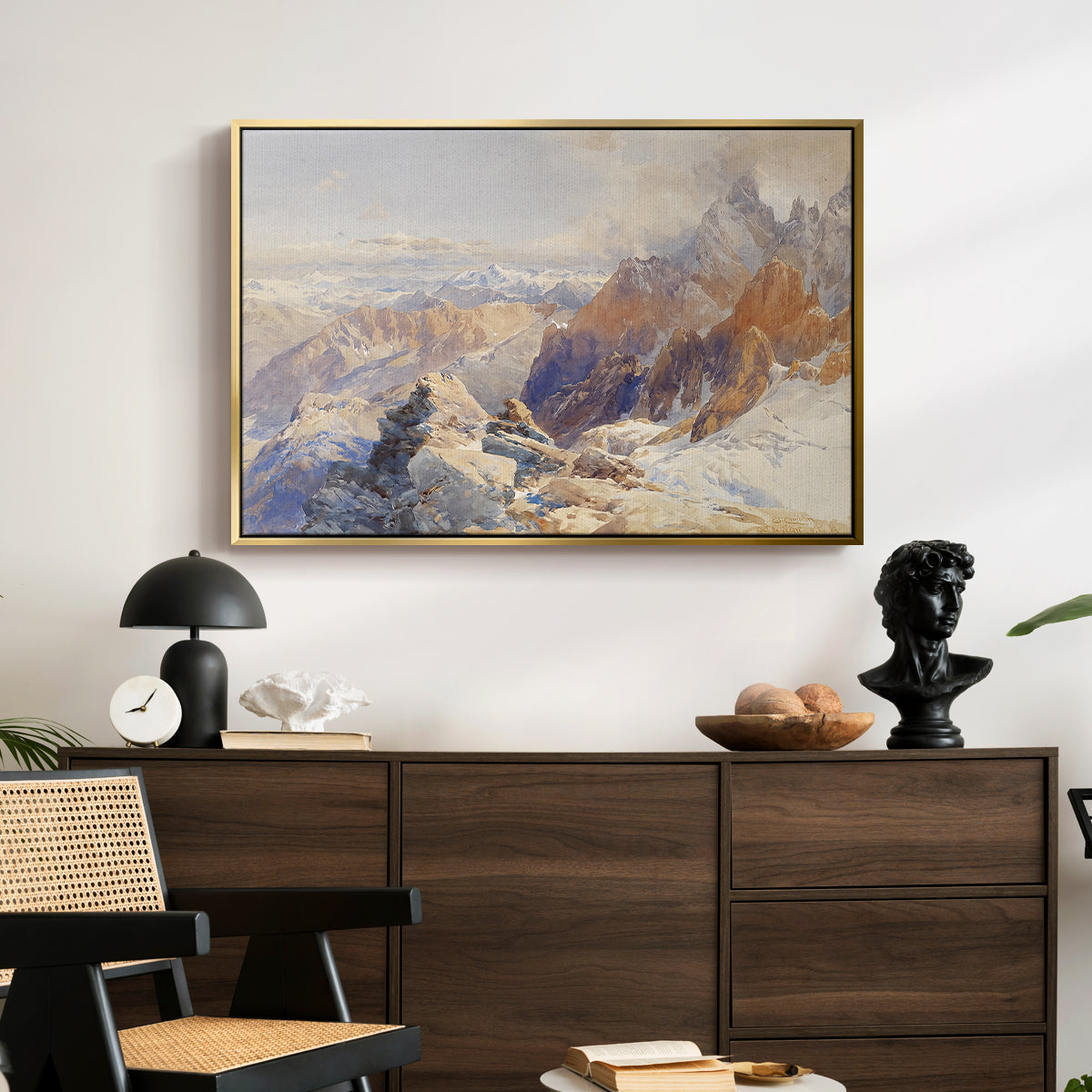 Col du Géant, 1903 by Edward Theodore Compton displayed in a gold floater framed canvas above a dark wood credenza in an entryway.
