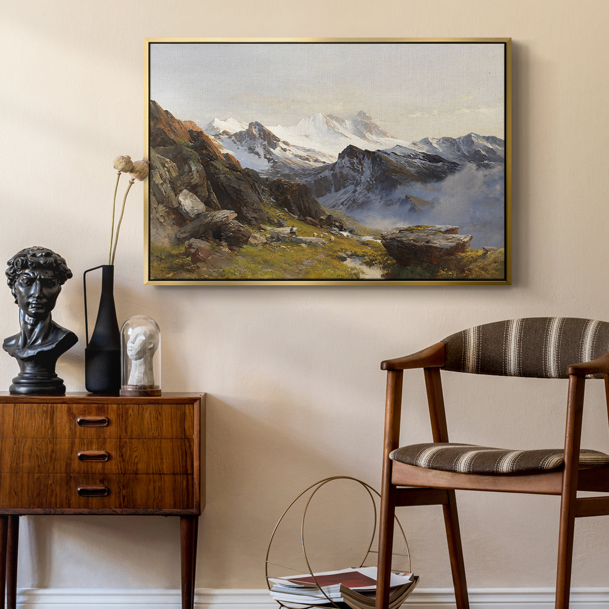 The Großglockner from the Prager Hut, 1890 by Edward Theodore Compton as a gold floater framed canvas featuring an alpine vista with towering peak and foreground terrain, styled above a mid-century console in a contemporary living area.