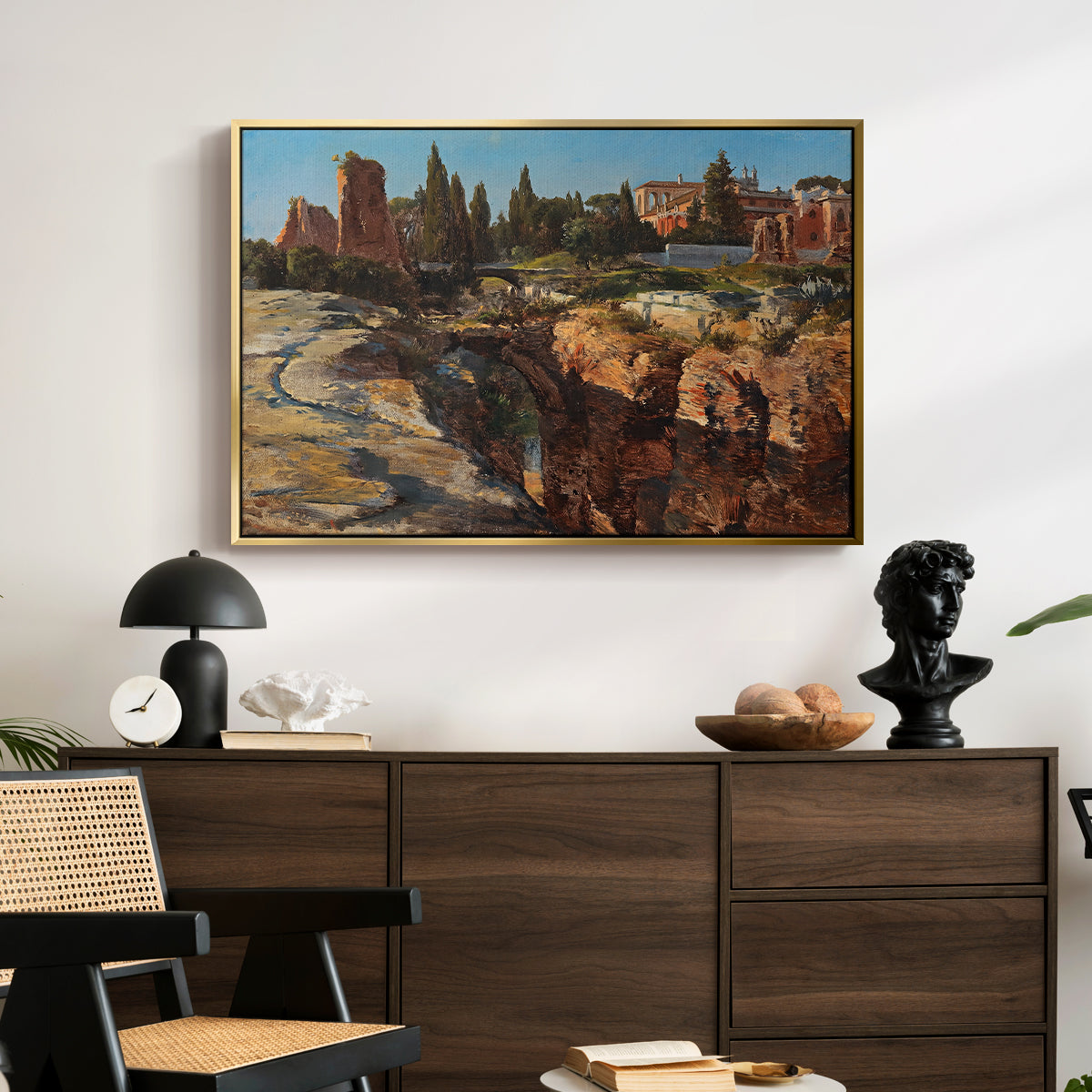Palatine in Rome, c. 1921 by Edward Theodore Compton displayed in a gold floater framed canvas above a dark wood credenza in an entryway.