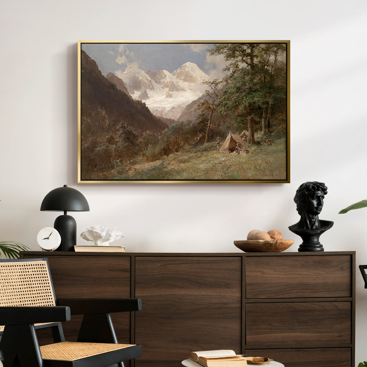 Landscape in the Caucasus, c. 1921 by Edward Theodore Compton displayed in a gold floater framed canvas above a dark wood credenza in an entryway.