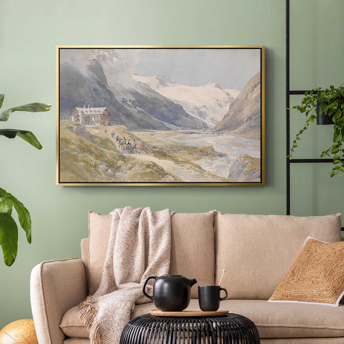Gold floater framed canvas featuring a natural landscape with human presence among mountains, displayed above a sofa in a modern living room.