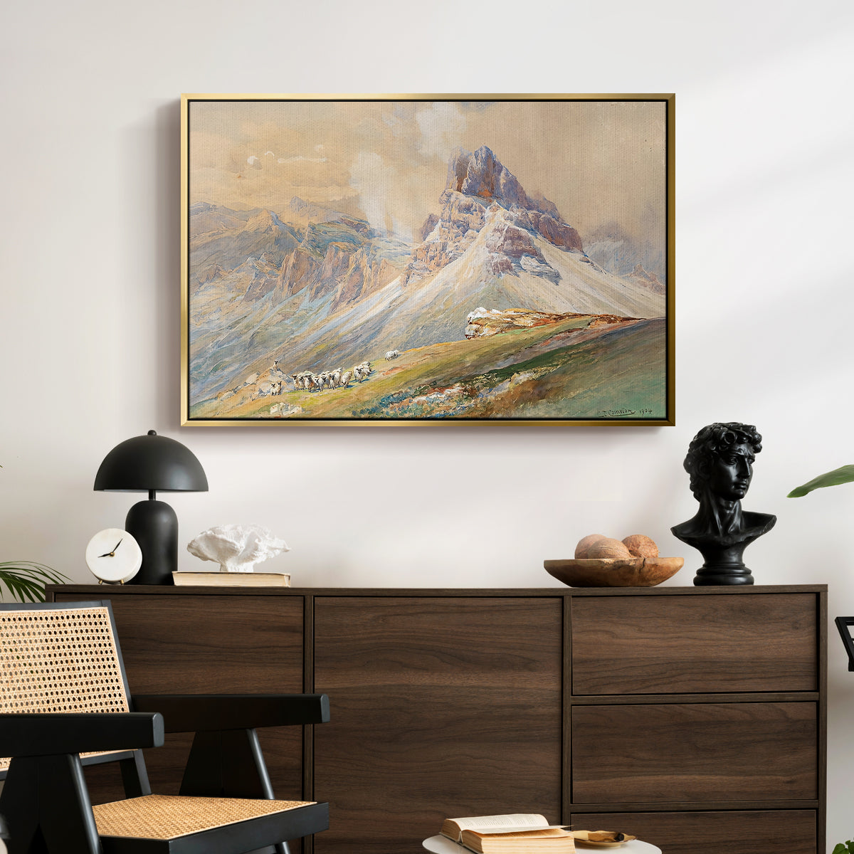 From the Dolomites, 1904 by Edward Theodore Compton displayed in a gold floater framed canvas above a dark wood credenza in an entryway.