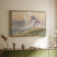 Gold floater framed canvas of From the Dolomites, 1904 by Edward Theodore Compton, featuring an alpine scene with jagged rock formations and distant mountains above a sideboard in a softly lit hallway.