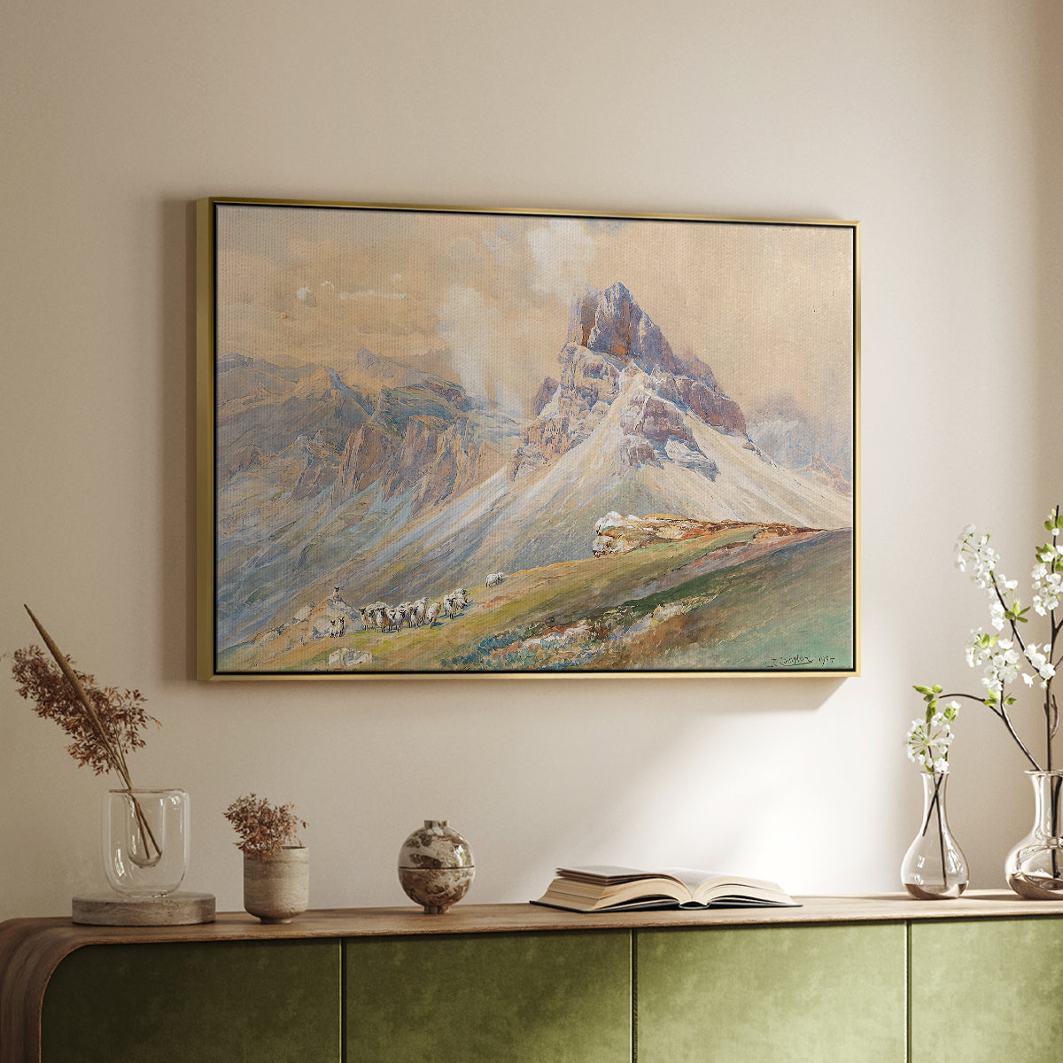 Gold floater framed canvas of From the Dolomites, 1904 by Edward Theodore Compton, featuring an alpine scene with jagged rock formations and distant mountains above a sideboard in a softly lit hallway.
