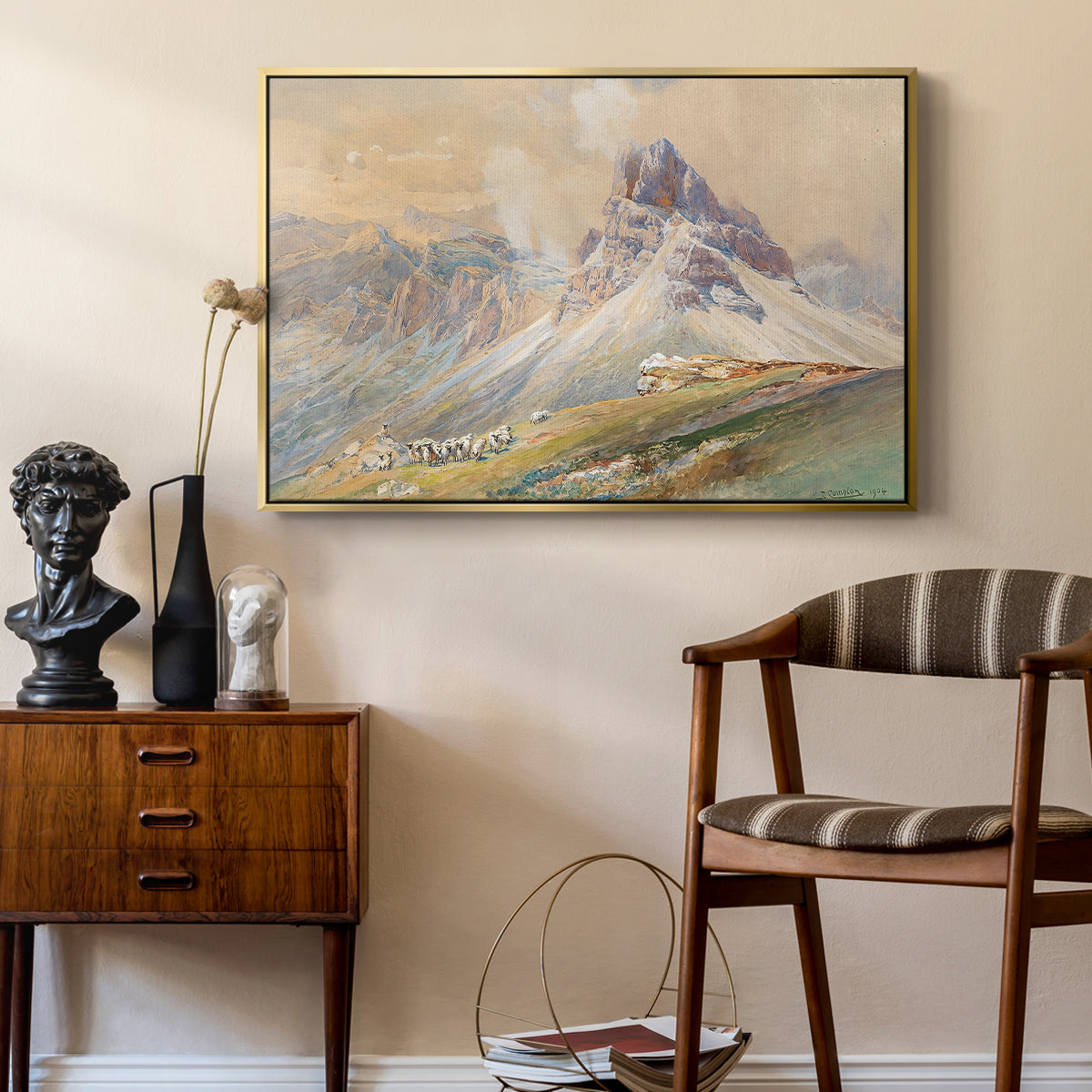 From the Dolomites, 1904 by Edward Theodore Compton as a gold floater framed canvas featuring an expansive landscape featuring iconic Dolomite peaks, styled above a mid-century console in a contemporary living area.