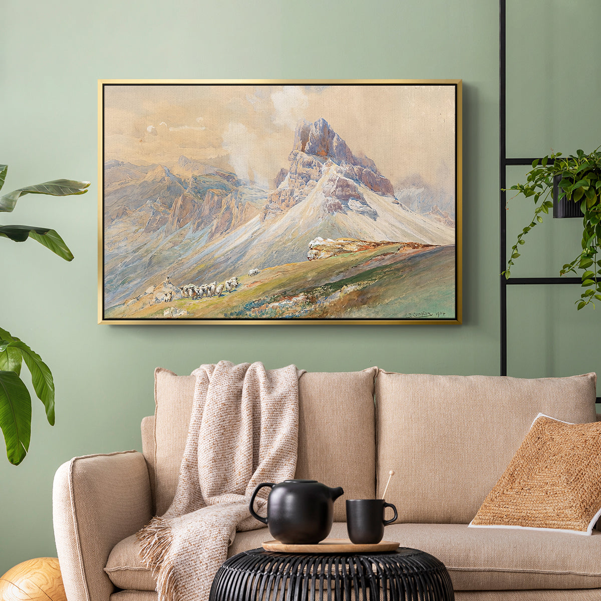 Gold floater framed canvas featuring a realistic mountain view with strong geological forms, displayed above a sofa in a modern living room.