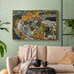 Gold floater framed canvas featuring an architectural scene with houses arranged in curved composition, displayed above a sofa in a modern living room.