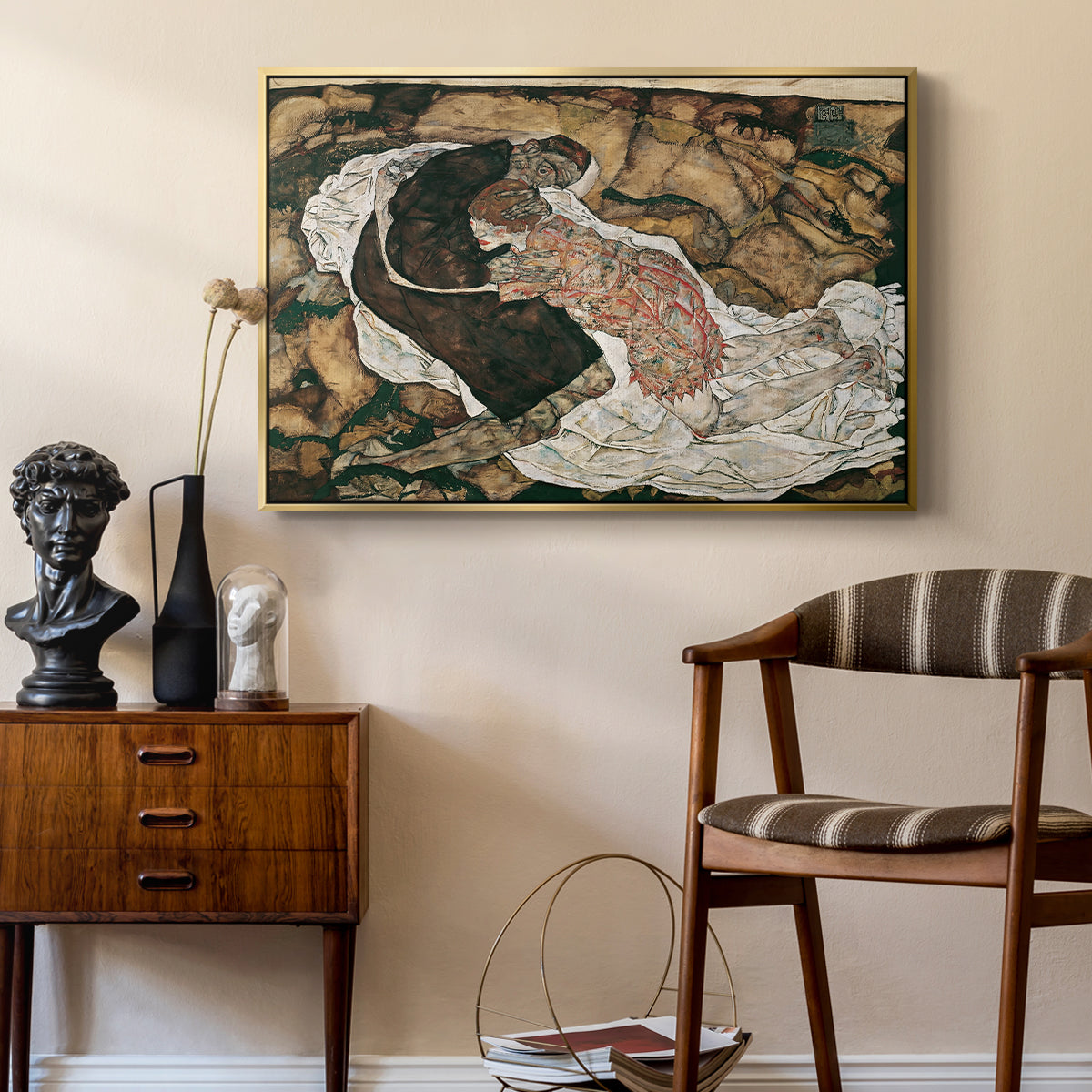 Death and the Maiden, 1915 by Egon Schiele as a gold floater framed canvas featuring an expressionist painting of human figures in dramatic pose, styled above a mid-century console in a contemporary living area.