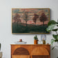 Four Trees, 1917 by Egon Schiele in a gold floater framed canvas featuring four trees standing in open landscape against colorful sky, displayed above a wood console cabinet.