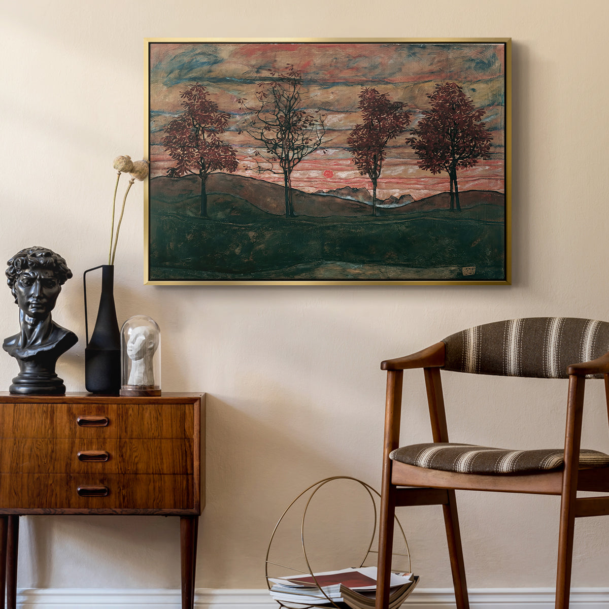 Four Trees, 1917 by Egon Schiele as a gold floater framed canvas featuring a stylized nature scene with strong outlines and simple composition, styled above a mid-century console in a contemporary living area.