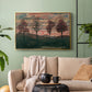 Gold floater framed canvas featuring an expressionist landscape featuring isolated trees in field, displayed above a sofa in a modern living room.