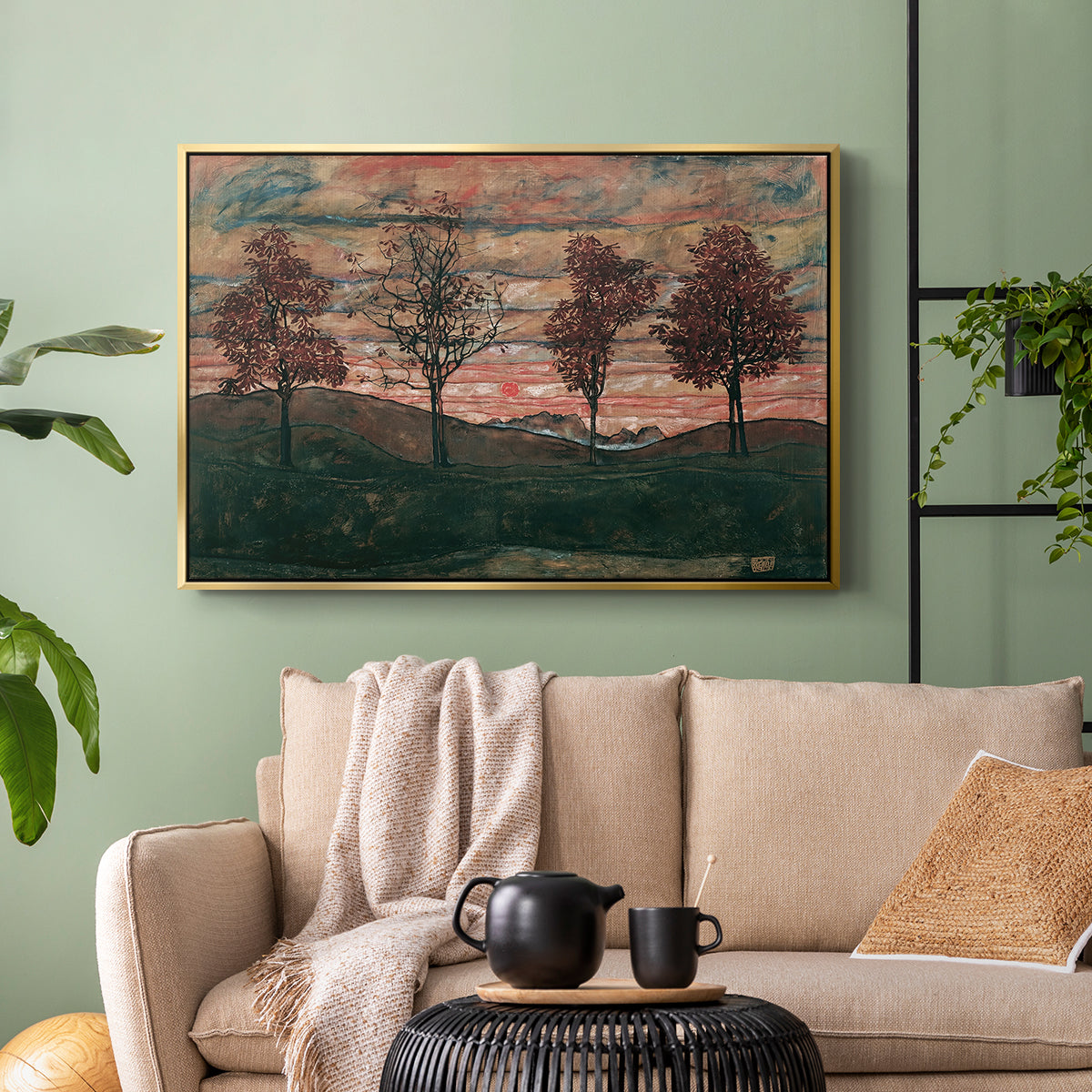 Gold floater framed canvas featuring an expressionist landscape featuring isolated trees in field, displayed above a sofa in a modern living room.
