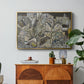 Mödling II, 1918 by Egon Schiele in a gold floater framed canvas featuring clustered geometric houses forming dense urban landscape with sharp angles, displayed above a wood console cabinet.
