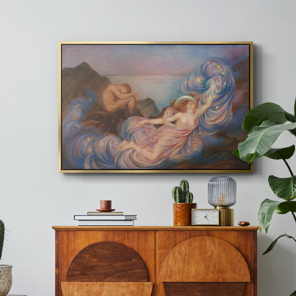 Twilight, 1914 by Evelyn De Morgan in a gold floater framed canvas featuring a reclining female figure beneath glowing sky at twilight with soft colors, displayed above a wood console cabinet.