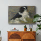 Tama, the Japanese Dog, c. 1876 by Pierre-Auguste Renoir in a silver floater framed canvas featuring a small black and white dog standing in shallow water with soft brushstrokes, displayed above a wood console cabinet.