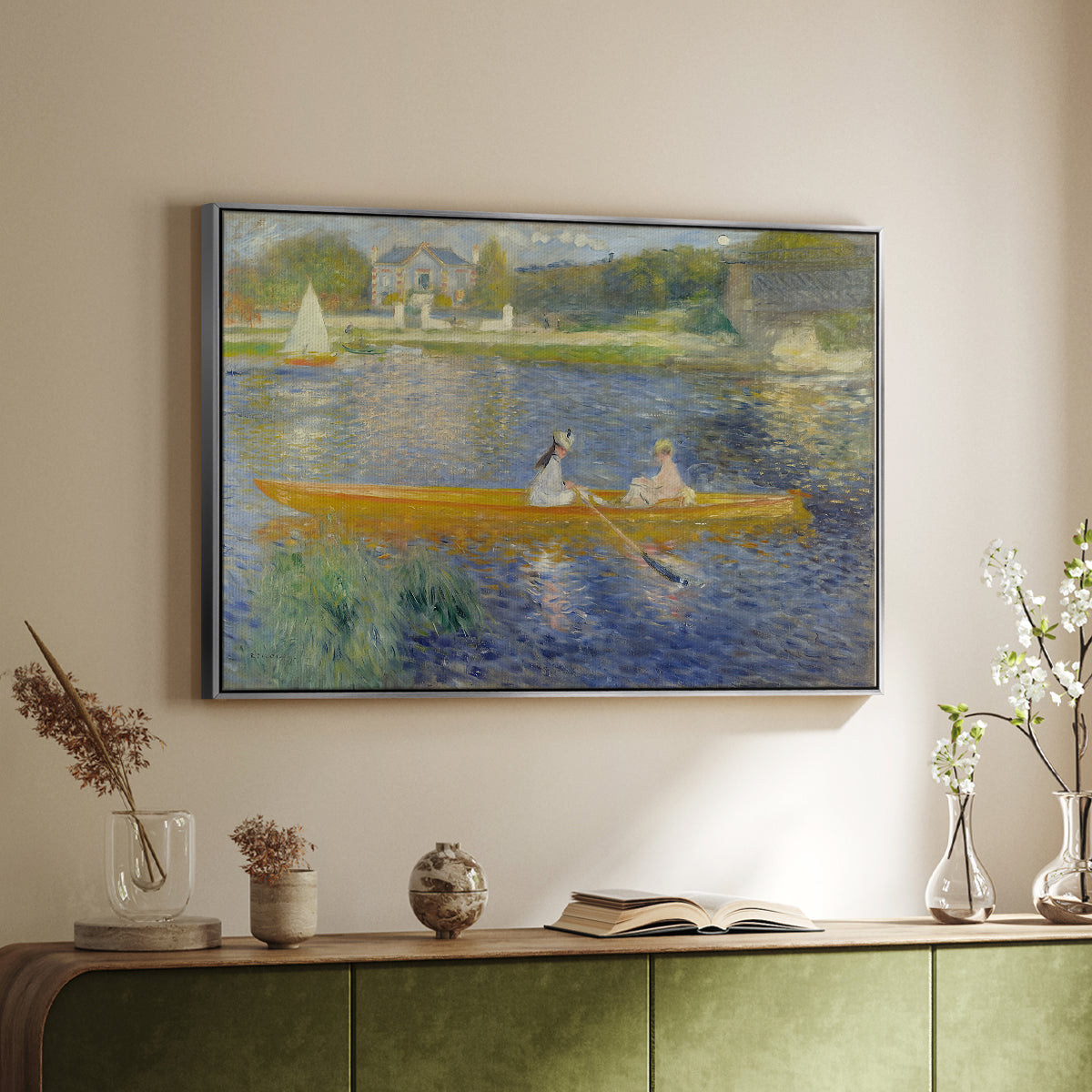 Silver floater framed canvas of The Skiff (La Yole), 1875 by Pierre-Auguste Renoir, featuring an impressionist boating scene with people relaxing in a narrow skiff above a sideboard in a softly lit hallway.