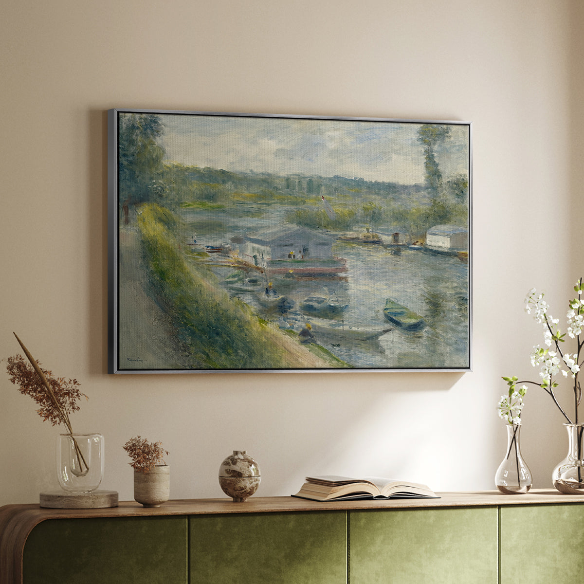 Silver floater framed canvas of Wash-House Boat at Bas-Meudon, c. 1874 by Pierre-Auguste Renoir, featuring a riverside scene with moored boat used for washing clothes above a sideboard in a softly lit hallway.