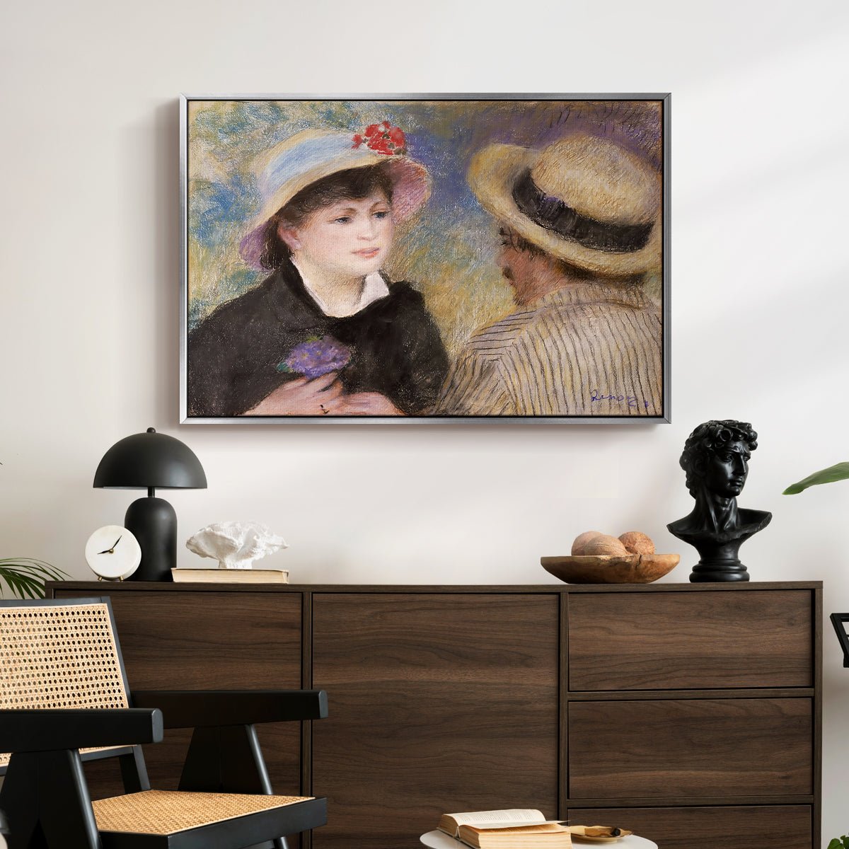 Boating Couple (Aline Charigot and Renoir), c. 1881 by Pierre-Auguste Renoir displayed in a silver floater framed canvas above a dark wood credenza in an entryway.
