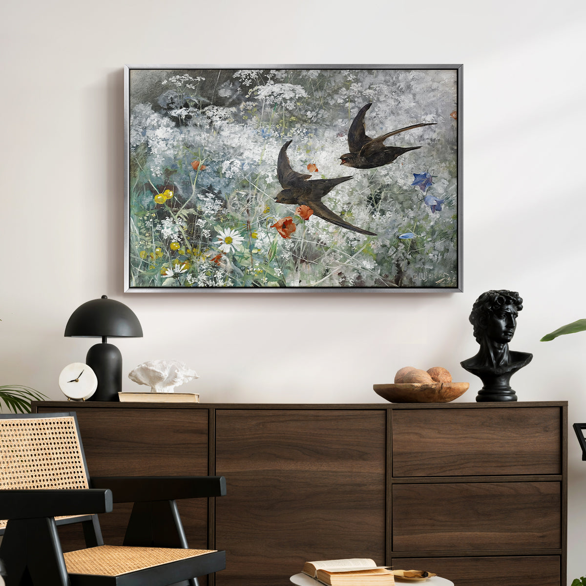 Common Swifts, 1886 by Bruno Liljefors displayed in a silver floater framed canvas above a dark wood credenza in an entryway.