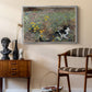 Cat on a Flowery Meadow, 1887 by Bruno Liljefors as a silver floater framed canvas featuring an animal scene of cat hidden in lush meadow vegetation, styled above a mid-century console in a contemporary living area.