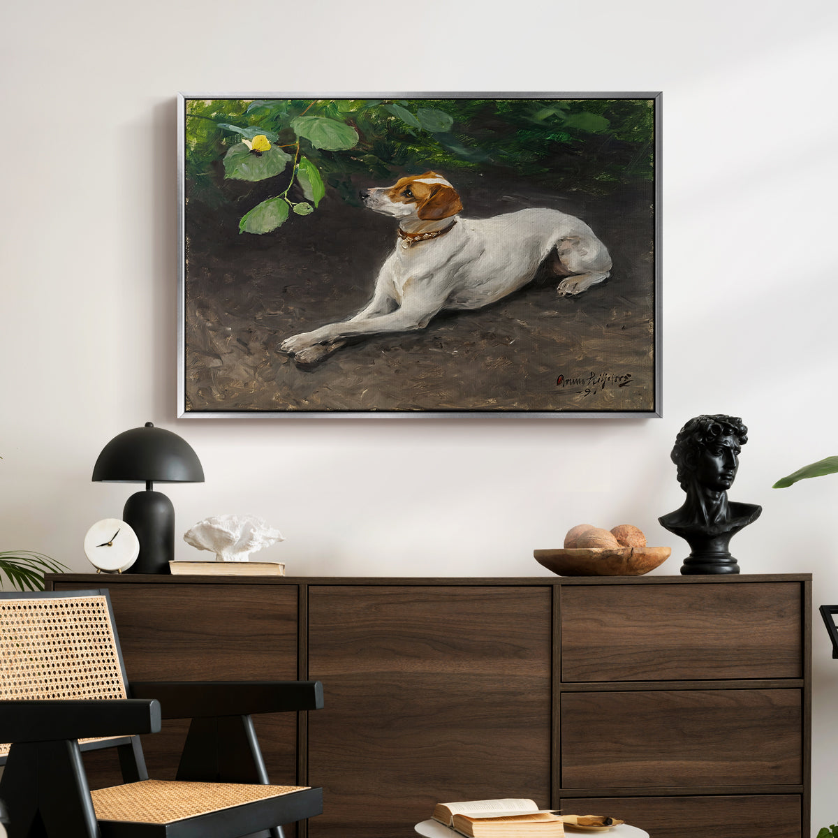 Portrait of a Dog, 1891 by Bruno Liljefors displayed in a silver floater framed canvas above a dark wood credenza in an entryway.