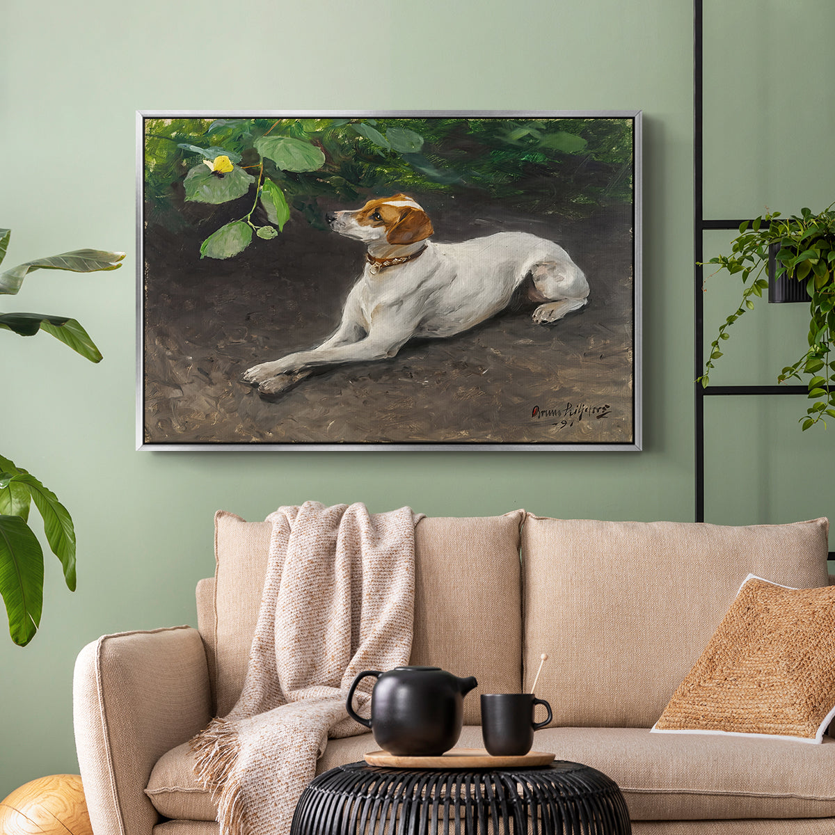 Silver floater framed canvas featuring a calm scene of dog reclining in open landscape, displayed above a sofa in a modern living room.