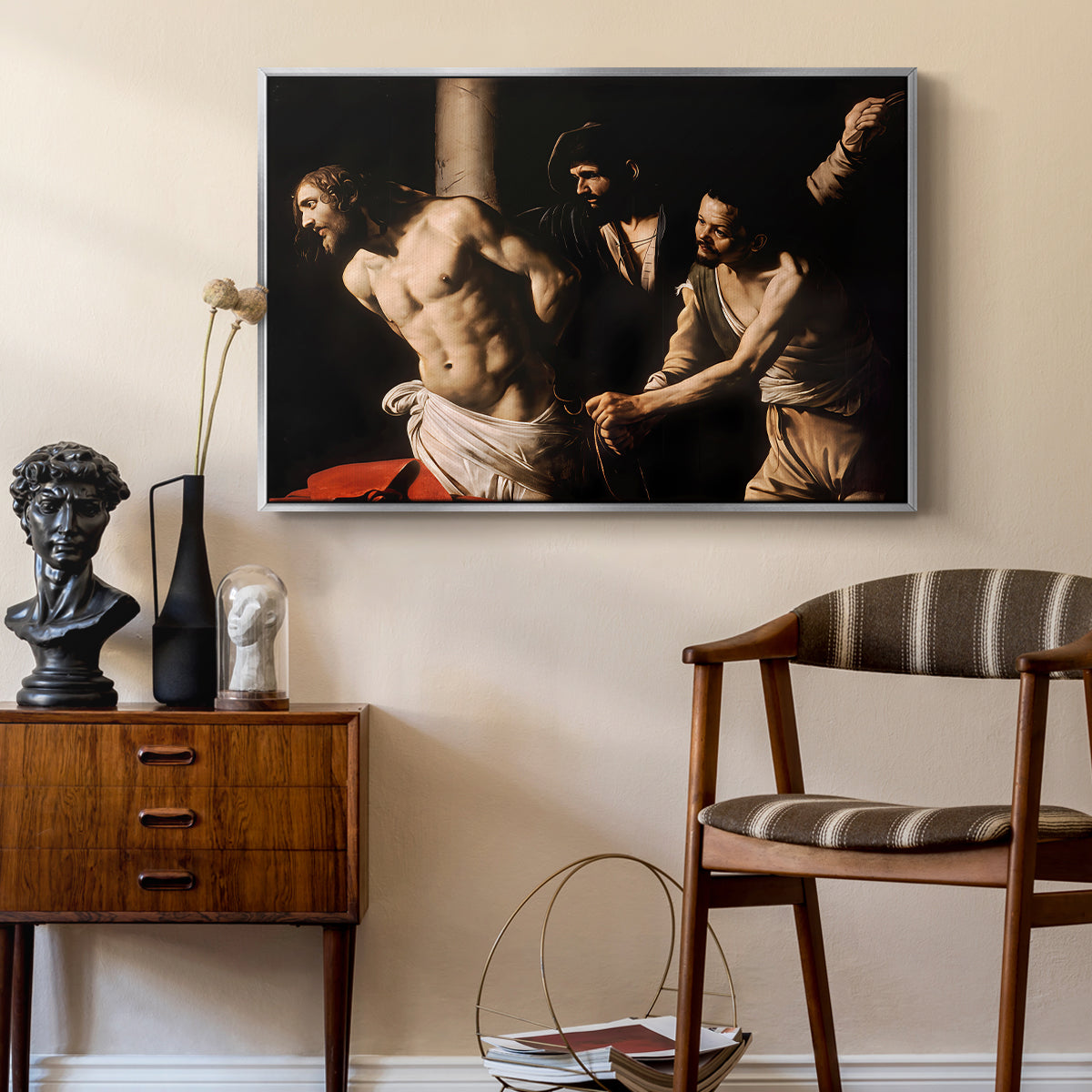 The Flagellation of Christ at the Column (Rouen Version), 1606 by Caravaggio as a silver floater framed canvas featuring a biblical depiction of men whipping Christ tied to pillar, styled above a mid-century console in a contemporary living area.