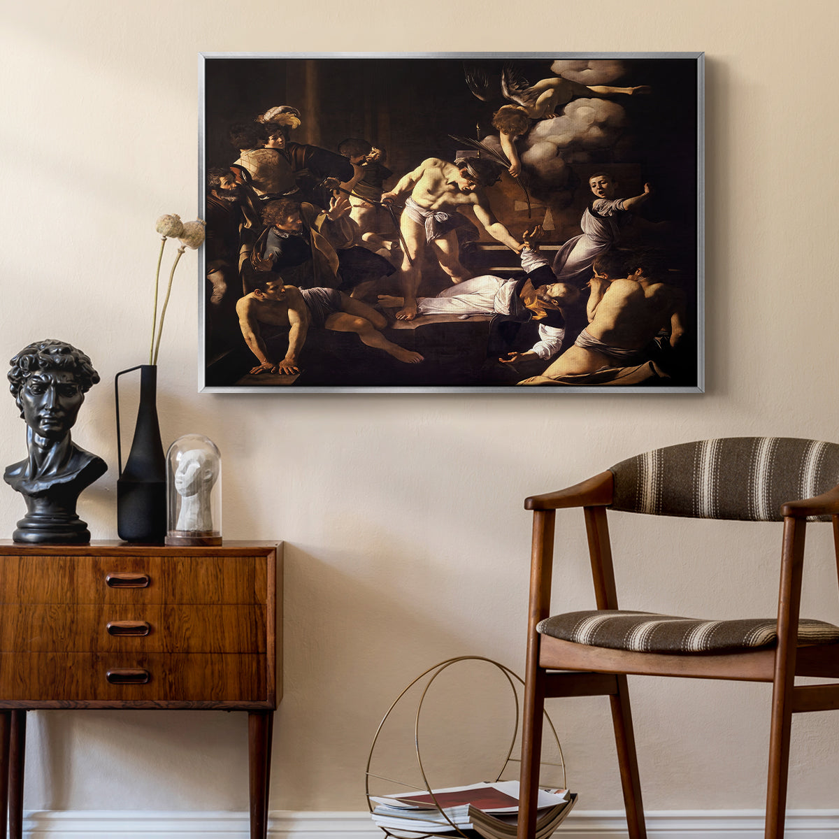 The Martyrdom of Saint Matthew, 1599-1600 by Caravaggio as a silver floater framed canvas featuring a religious narrative showing violent attack on saint in crowded setting, styled above a mid-century console in a contemporary living area.