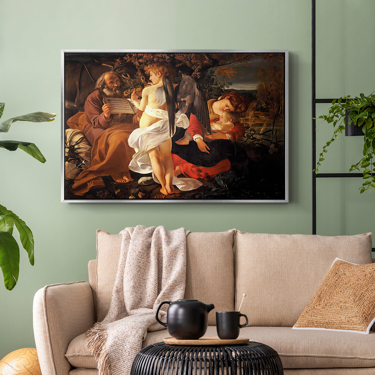 Silver floater framed canvas featuring a Baroque landscape with angel playing music for resting travelers, displayed above a sofa in a modern living room.