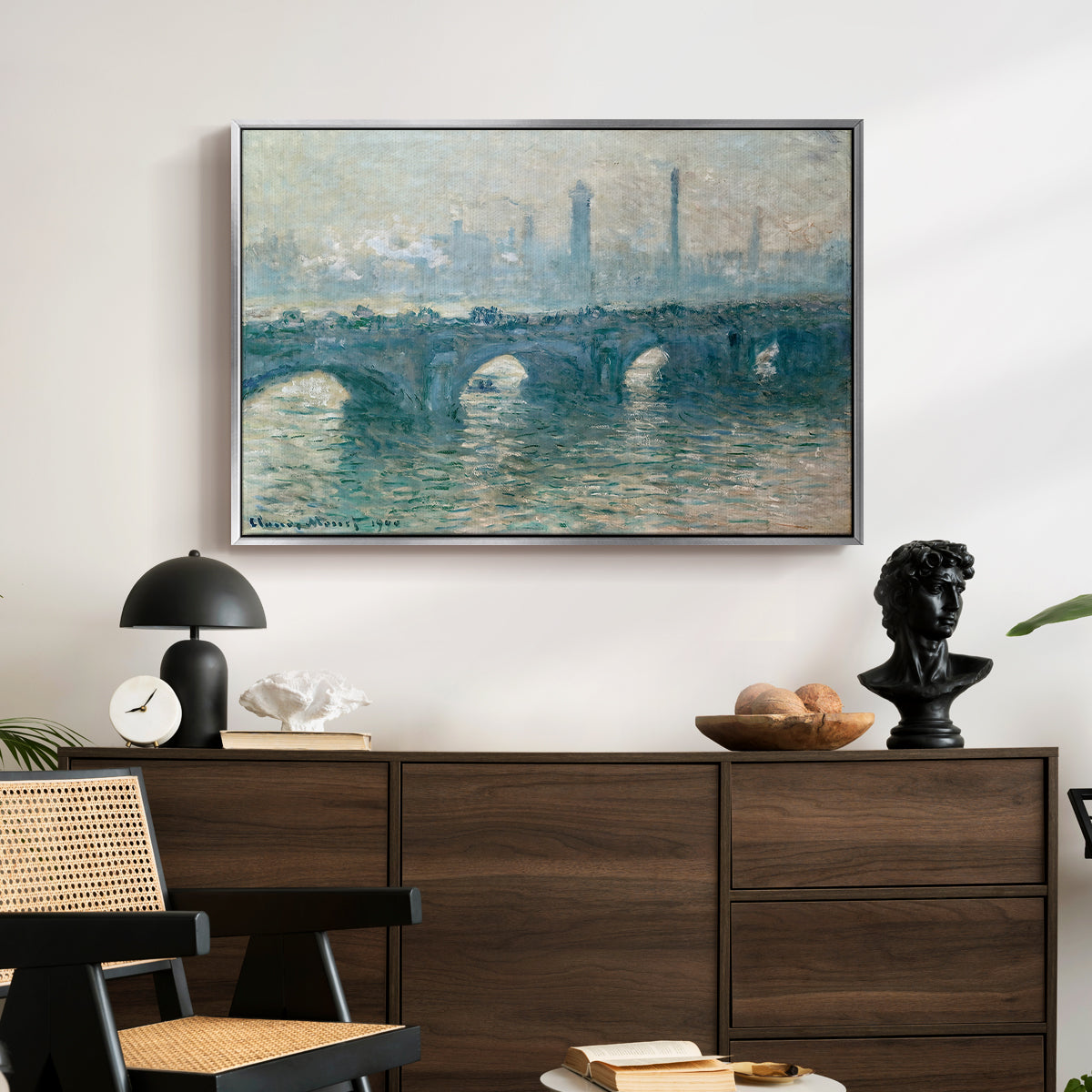 Waterloo Bridge, Gray Weather, 1900 by Claude Monet displayed in a silver floater framed canvas above a dark wood credenza in an entryway.