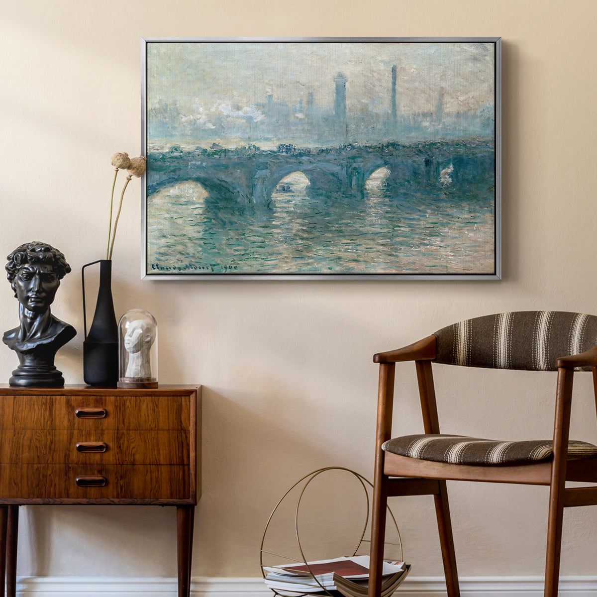 Waterloo Bridge, Gray Weather, 1900 by Claude Monet as a silver floater framed canvas featuring a soft-toned river scene with bridge and muted skyline, styled above a mid-century console in a contemporary living area.